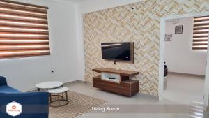 a living room with a flat screen tv on a wall at StayMazing Manyata-1BHK Boutique AC Apartments -Couple Friendly in Bangalore