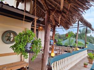 a patio of a restaurant with tables and chairs at Hill View Garden Hotel in Moshi