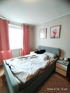 a bedroom with a large bed with red curtains at 3-room Apartment Berlin Museum Island 2 beds in Berlin