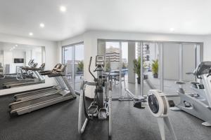 a gym with treadmills and cardio equipment in a building at Oaks Darwin Elan Hotel in Darwin