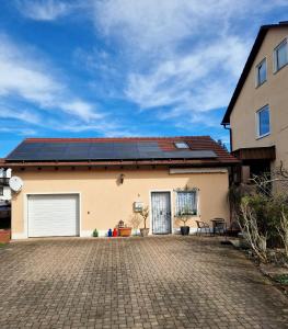 a house with solar panels on the roof at Schönes Apartment / Ferienwohnung am Regen in Blaibach