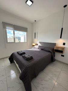 a bedroom with a large bed and a window at Patagonia House - Mayo in Puerto Madryn