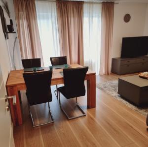 a living room with a wooden table and chairs at Emma in Oldenburg