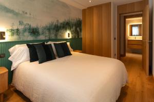 Tarter Mountain & SPA في التارتر: غرفة نوم مع سرير أبيض كبير مع وسائد سوداء