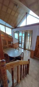 a dining room with a table and a bench at Hotel Jubilant Manali in Manāli