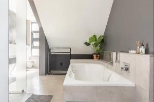 a large white tub in a bathroom with at Chez ArtéKatz in Cape Town