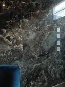 bagno con parete in marmo nero di La Chambre Delta a Morlanwelz-Mariemont