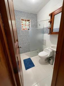 a bathroom with a toilet and a blue rug at Hotel PedidoSia in Higuey