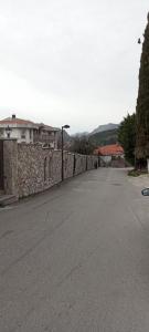 an empty street next to a stone wall at Extra lokacija!!!!! in Sutomore +8 photos