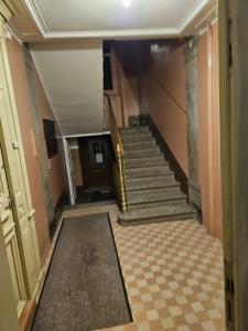 a hallway with a staircase in a building at Standard room in La Chaux-de-Fonds