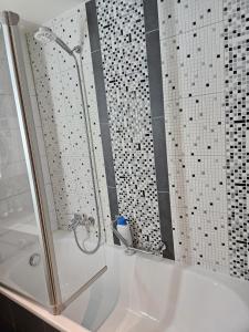 Das Bad ist mit einer Dusche und einer Badewanne ausgestattet. in der Unterkunft Standard room in La Chaux-de-Fonds