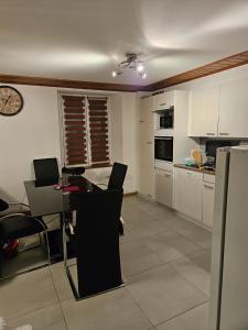 uma cozinha com mesa e cadeiras num quarto em Standard room em La Chaux-de-Fonds