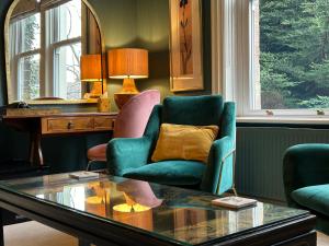 a living room with two chairs and a table at Baytree House in Harrogate