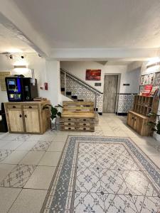 a large room with a tile floor and a staircase at Hotel Les Palmiers En Camargue in Saintes-Maries-de-la-Mer