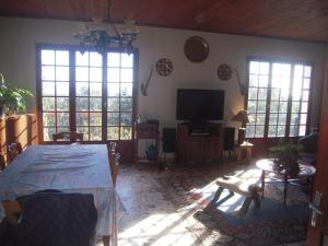 a living room with a table and a television at CASA DI SIGNARE in Ventiseri +12 photos