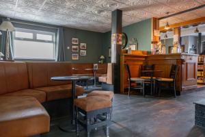 a bar with a couch and a table and chairs at Four Bedroom House By Travel Lets Self Catering Accommodation Ballygowan With Near Belfast in Ballygowan