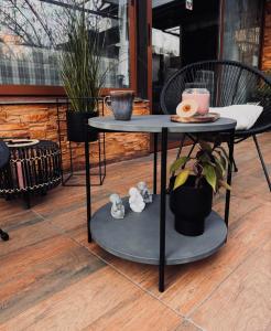 a table and a chair on a patio at Priyateli - Friends in Veliko Tŭrnovo