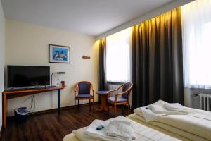 TV a/nebo společenská místnost v ubytování Hotel Stadt Daun