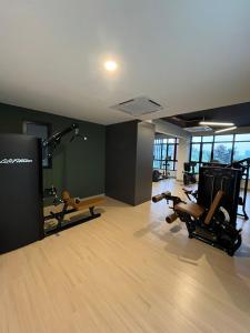 a gym with two treadmills and chairs in a room at Raida Homestay in Putrajaya