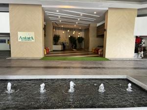 a group of swans in a fountain in a lobby at Raida Homestay in Putrajaya