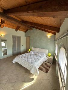 a bedroom with a large bed with a wooden ceiling at La tana di Piozzo in Piozzo
