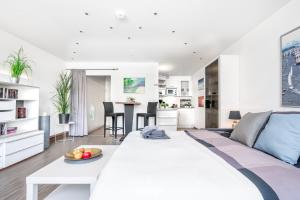 a living room with a white couch and a table at Ferienwohnung Marina Apartment 9403 in Marina Wendtorf in Wendtorf