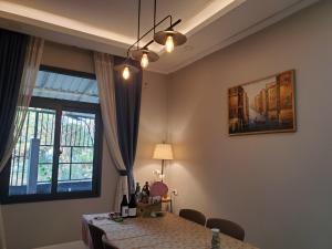 a dining room with a table and a window at Apartment in Vientiane
