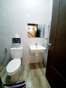 a bathroom with a toilet and a sink at Apartment in Vientiane