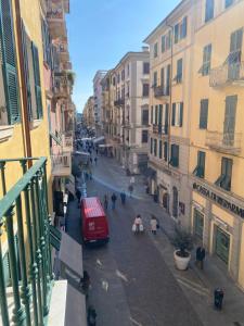 a view of a city street with a red van at 54 ROSSELLI ROOMS in La Spezia