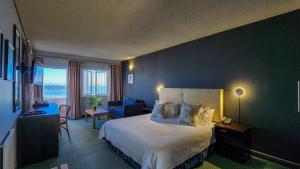 a hotel room with a bed and a blue wall at The Blue Peter Hotel in Cape Town