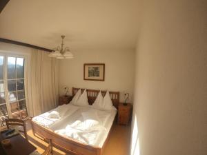 a bedroom with a bed with white sheets and a window at Landhaus Aflenz in Aflenz Kurort