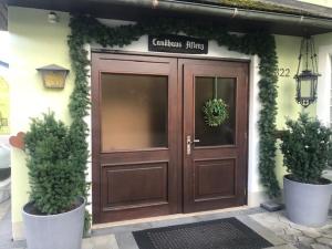 a brown door with two potted plants in front of it at Landhaus Aflenz in Aflenz Kurort
