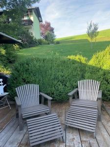 two chairs sitting on a deck with a view of a yard at Landhaus Aflenz in Aflenz Kurort