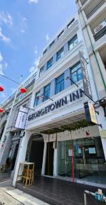 a building with a sign on the front of it at Georgetown Inn by Sky Hive in George Town