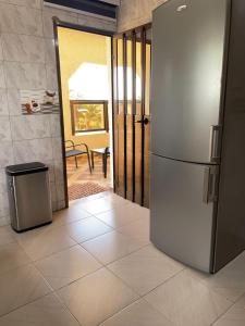 a kitchen with a stainless steel refrigerator and a doorway at Wendyla Luxury's in Bé