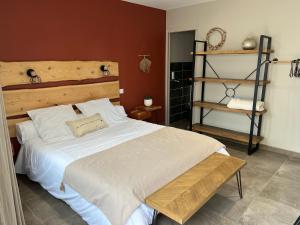 a bedroom with a large white bed and a shelf at La Rose des Vents in Le Crotoy
