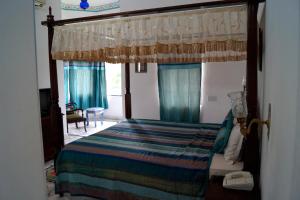 a bedroom with a bed with a canopy at Karohi Haveli - A Heritage Hotel in Udaipur
