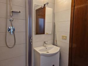 a bathroom with a sink and a mirror at Vico 2 monolocale in Albissola Marina