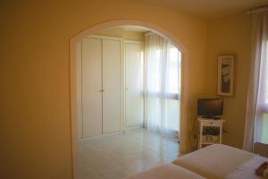 a bedroom with an archway with a bed and a television at Espectacular Casa en La Garriga in La Garriga
