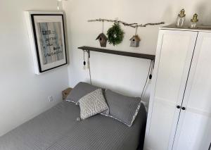 a bedroom with a bed and a shelf on the wall at Chalet Du Marais in Saint-Paulin