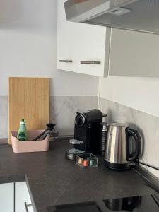 a kitchen counter with a coffee maker and a toaster at Stadtnahes Appartment mit Waldblick in Würzburg