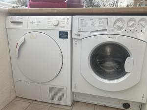 a washing machine and a dryer sitting next to each other at Mariners Corner in Bexhill