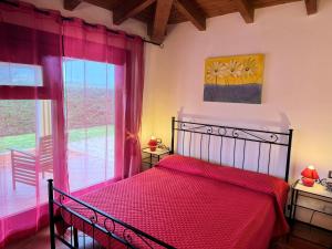 a bedroom with a bed and a large window at Villa Holiday Park Stintino in Stintino