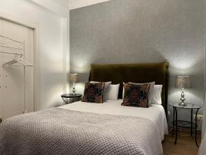 a bedroom with a large white bed with two lamps at Céntrico Apartamento in A Coruña