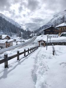 a road covered in snow next to a fence at PUNTA VITTORIA SUB 14 - RESIDENCE ANDERBATT GRESSONEY - 3 locali - CIR N 0010 in Staval
