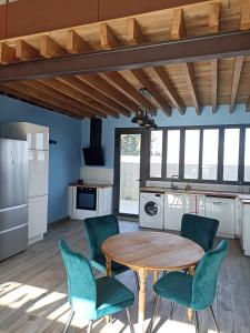 a kitchen with a table and chairs in a kitchen at Campagne et Mer in Perpignan