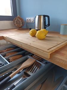 two stuffed animals sitting on a cutting board in a kitchen at Grande maison de vacances in Perpignan