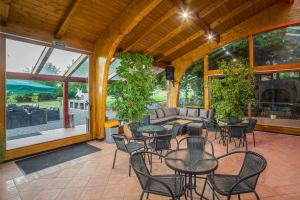 a patio with tables and chairs and a couch at Partyház Gödöllő in Gödöllő