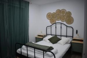 a bedroom with a bed with a metal headboard at Casa Jose y Angeles in La Herradura