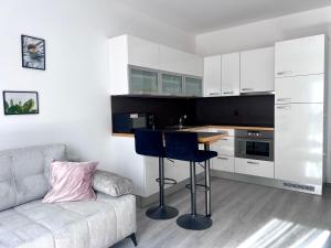 a living room with a couch and a table in a kitchen at Apartmán Lakeside in Český Krumlov